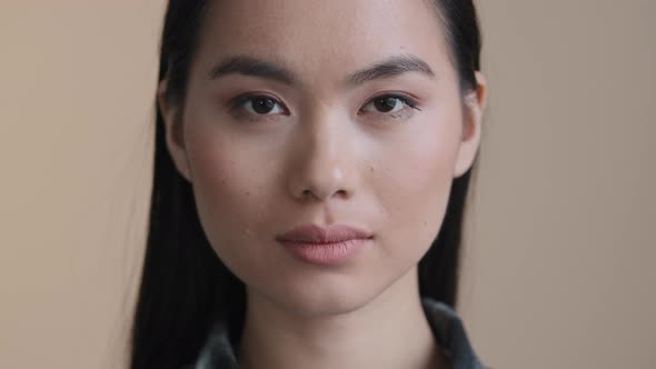 Asian Serious Calm Female Face Close Up Portrait Millennial 30s Woman with Perfect Skin Natural Make alt