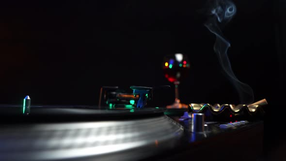 DJ Booth in 1980's Disco Nightclub Party Spinning Vinyl Record on Gramophone alt