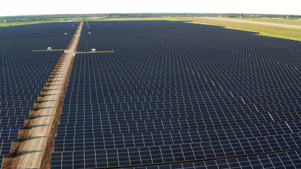 Top view of the power plant with solar panels. Beautiful green fields. alt