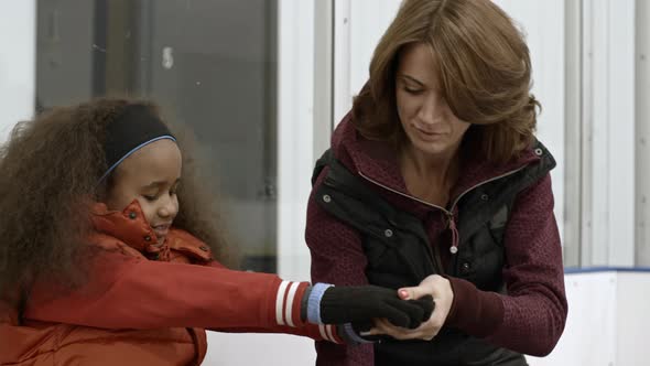 Coach Explaining Girl New Figure Skating Position alt