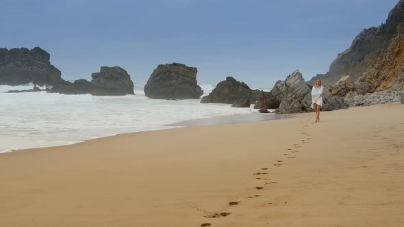 Sexy Woman Walks Over a Sandy Beach at the Ocean  Extreme Slow Motion alt