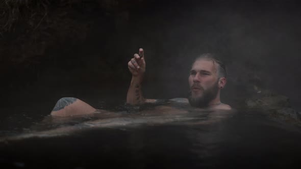 Close Shot of a Man Submersed in Steaming Water alt