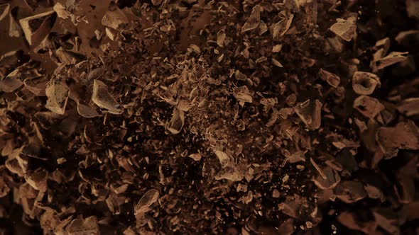 Super Slow Motion Shot of Raw Chocolate Chunks and Cocoa Powder After Being Exploded at 1000Fps. alt