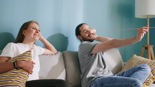 Couple Has Fun Using Paper Cup Phone alt