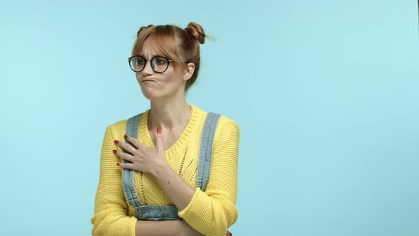 Funny Hipster Woman in Nerdy Glasses Standing Pensive Over Blue Background Thinking and Then