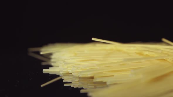 Spaghetti Fall On A Black Table - Side View