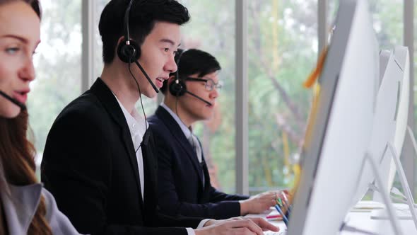 Call center man support specialist talking on a headset with customer