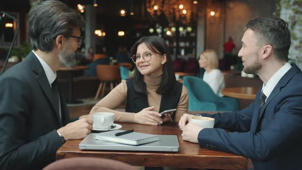 Business Men Talking Discussing Deal with Interpreter Then Shaking Hands in Restaurant alt