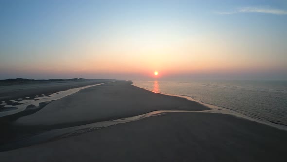 Cinematic low flight over the ocean's shore alt