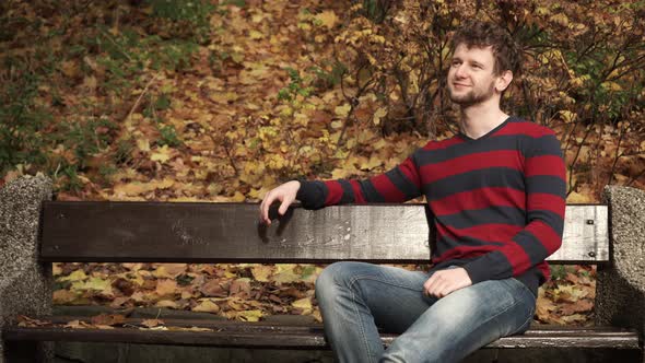 Man on Bench in Autumn Park 