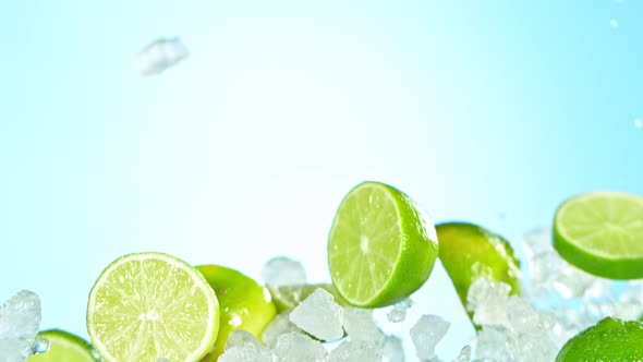 Super Slow Motion Shot of Flying Fresh Lime Slices and Crushed Ice on Blue Background at 1000 Fps alt