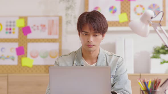 Asian man having neck and shoulder pain during work at home alt