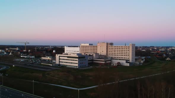 Drone overview of a hospital during sunset. alt
