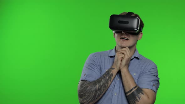 Man Using VR App Helmet To Play Simulation Game, Drawing. Guy Watching Virtual Reality 3d Video alt