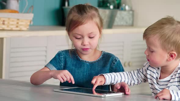 Caucasian Children Using Tablet Together at Home