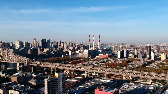 Vehicles Travelling At Queensboro Bridge Passing By The City of Long Island In New York City, USA. - alt