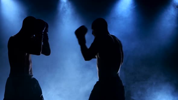 Boxing Two Young Sportsman in a Smoky Studio in Silhouette alt