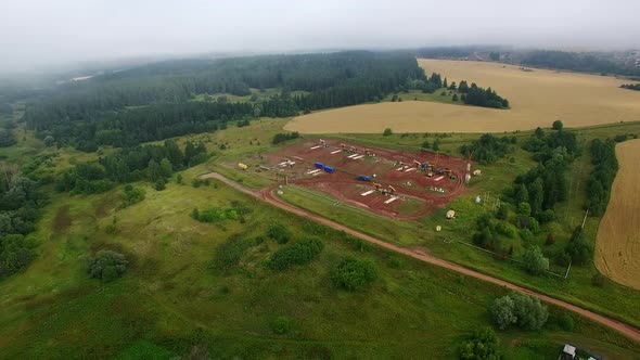 Aerial Foggy Panorama of Oil Pumps at Oilfield Cluster