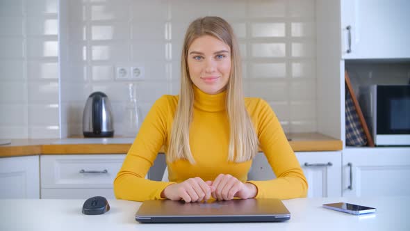Happy blonde female working freelance from home during lockdown in 4k footage alt