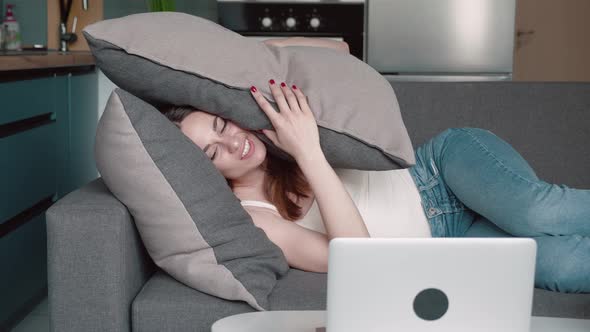 Young Woman Sleeping on Pillows Under Plaid in Bed in Early Morning alt