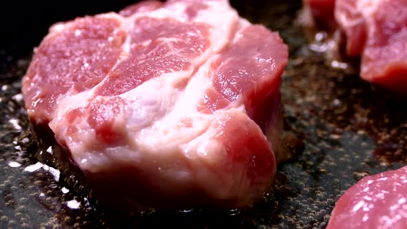 A Piece of Raw Meat Is Fried in Oil