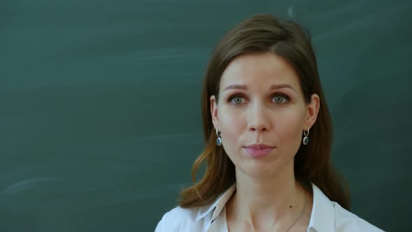 Young Female Teacher Tell Interesting To Class Near the Blackboard alt