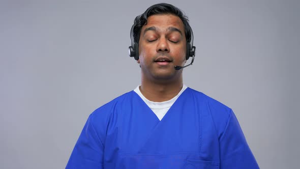 Indian Doctor in Headset Having Conference Call alt