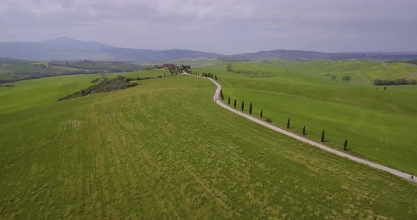 5692 Aerial, Beautiful Green Hills And Fields And Cypresses Landscape In Tuscany, Italy