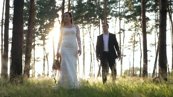 Stylish and tender couple in love - the bride and groom in the park alt