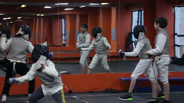 Kids practicing fencing at a fencing school