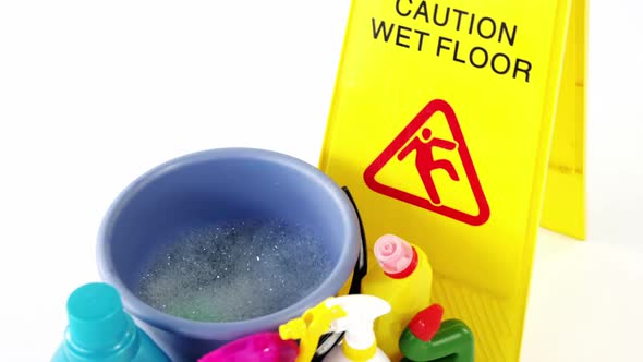 Various housekeeping supplies with caution sign alt