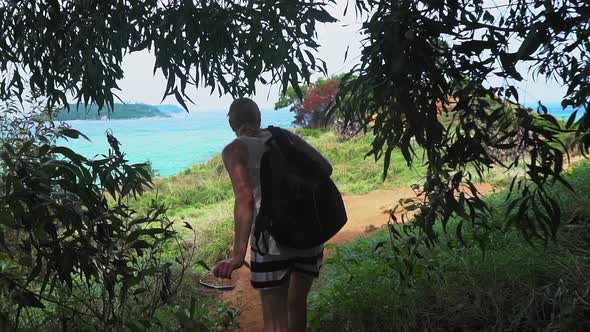 girl with a backpack travels through a tropical island. tourist place. seascape alt