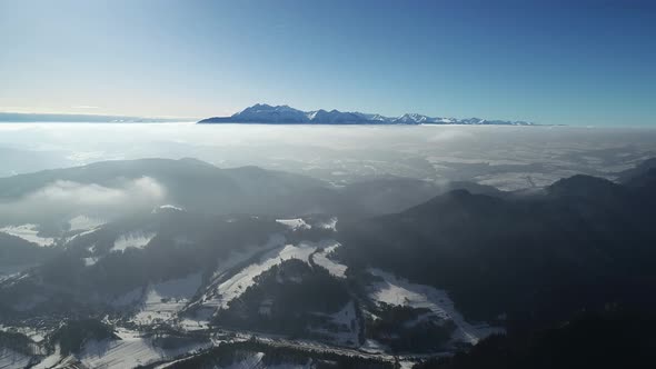 Winter in high mountains. Aerial view of beautiful winter snowy white scenery in mountain. 