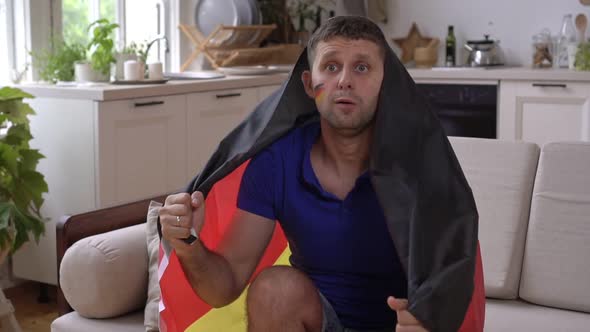German Football Fan Watches TV and Rejoices at Victory Slow Motion alt