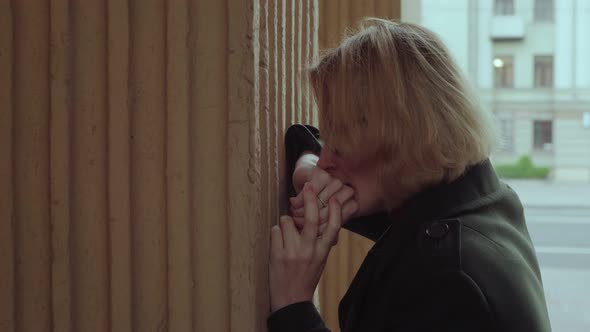 Abused Woman Crying Near Wall Outdoors alt