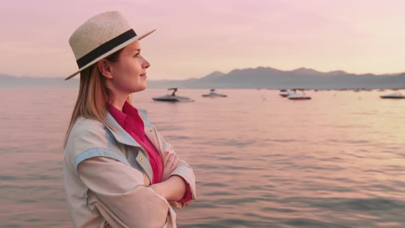 Happy Caucasian Woman Dreaming Contemplating Relaxing at Lake Tahoe at Sunset alt