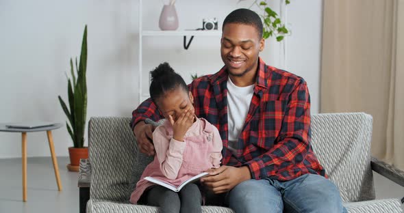 Afro American Father Ethnic Teacher Older Brother Teaches Little Funny Girl to Read Kid Holding Gray alt