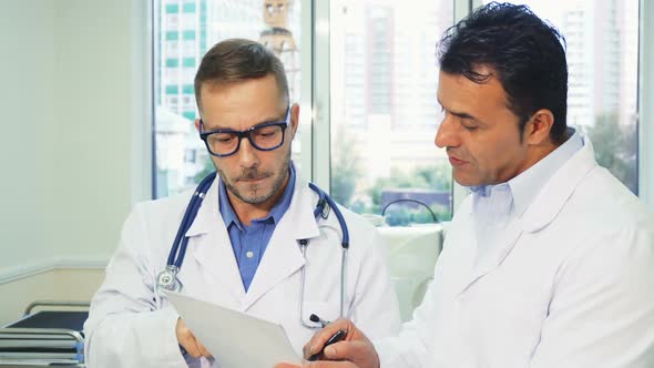 Two Experienced Doctors Read the Patients Medical Certificate alt