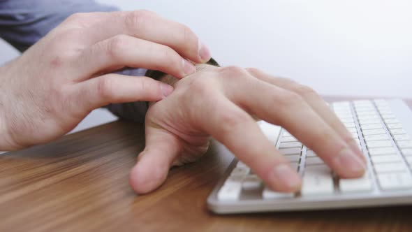 A Businessman Uses a Smartwatch at His Desk to Schedule an Appointment alt