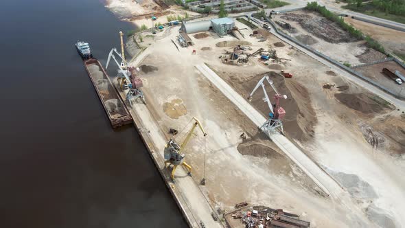 Large Harbor Cranes on the Shore at the Pier alt