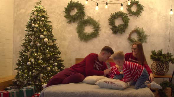 Cheerful Family Having Fun Together on Bed