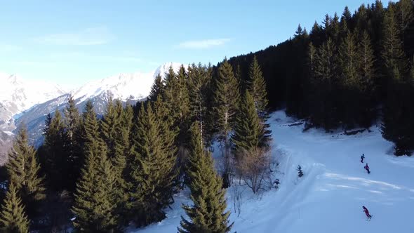 Aerial Winter Scene of Alpine Snowy Mountain Peaks and Dark Spruce Forest in Snow