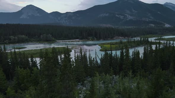 Stunning Bow River flowing through the Rocky Mountains at blue hour in Alberta, Canada. Wide angle a alt