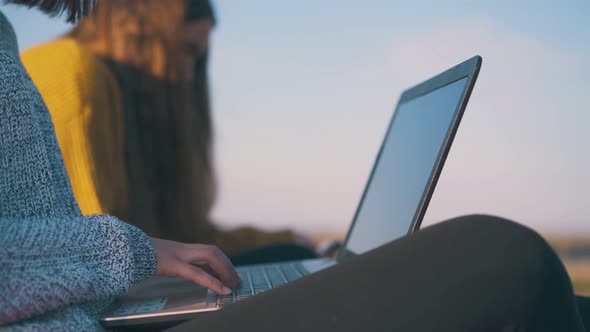 Woman with Laptop Near Friend at Campsite in Autumn Evening alt