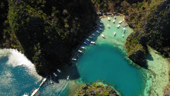 Spider boats parked in Blue lagoon aerial view in Coron, Palawan, Philippines alt