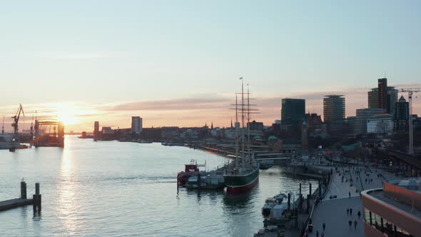 People Enjoying Evening Walk on the River Bank By Elbe River in Hamburg Germany alt