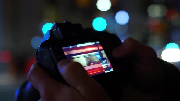 Photographer At Night Reviewing Picture With Beautiful Bokeh 2