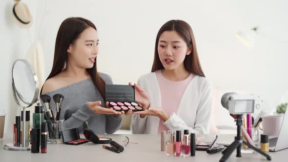 Young two beautiful Asian woman beauty influencers doing cosmetic review online