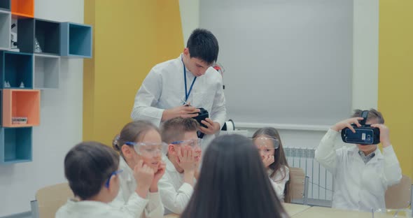Schoolboy Using Virtual Reality Glasses in Classroom at School alt