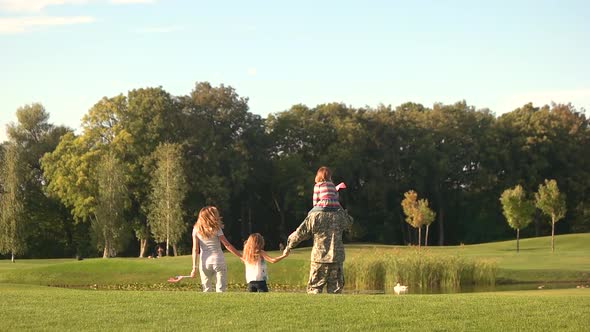 Family and Soldier in a Military Uniform Walking Away, Slow Motion alt